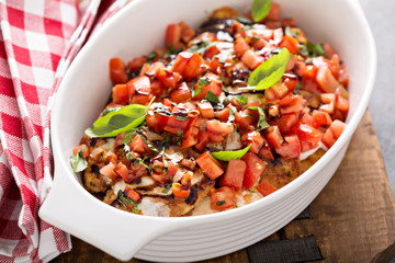 Bruschetta chicken with cheese, fresh tomatoes and basil