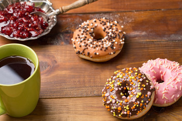 Dougnut filled with crimson jam and cold coffee - Hanukkah