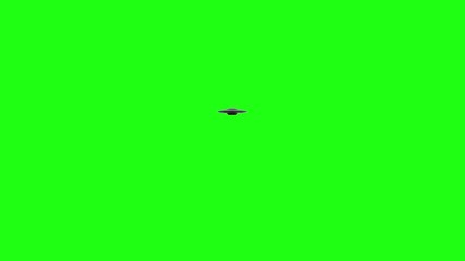 Flying Saucer UFO rotates moving over top of green screen. Moves over and away from camera into the distance green screen
