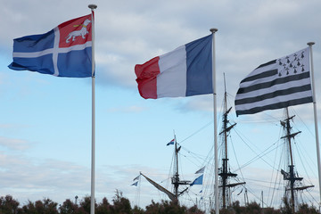 flags of Brittany and France in the background of the ship