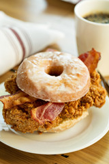 Fried chicken and bacon sandwich in a donut