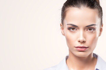 Fototapeta premium Beauty close up portrait of female face with natural skin at white background