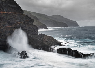 Strong surf on a rocky coast in stormy weather, water movement in long exposure - Location: Spain, Canary Islands, La Palma
