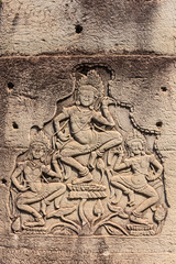Fototapeta na wymiar Carving of men dancing at the Unesco World Heritage site of Ankor Thom, Siem Reap, Cambodia