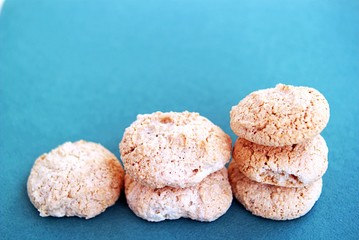Crispy meringue with almonds on a turquoise background
