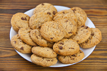 delicious appetizing cookies with chocolate on plate