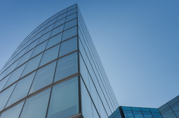 Fototapeta na wymiar Glass facade, modern architecture with blue sky, morning shoot.