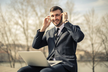 Cheerful manager using technology