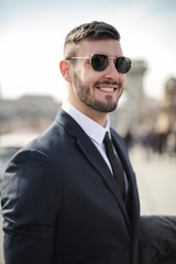 Smiling businessman with sunglasses