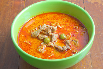Thai food. Pork panang curry on wood background.