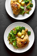 Baked chicken leg with potato and green salad