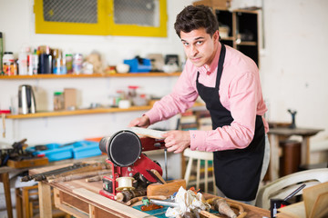 Carpenter working on manual lathe