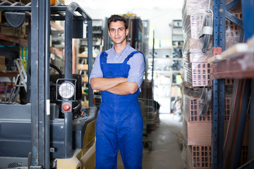 Fototapeta na wymiar Portrait of attentive male in uniform on his workplace in building store.
