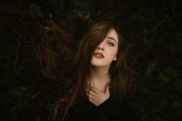 Young Woman with Blue Eyes With Hair Tangled in a Tree