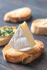 Toast with Camembert cheese on the wooden board
