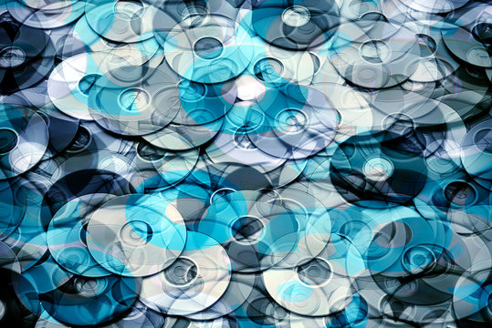 Conceptual photo illustration of silver blue DVD and CD disks create data technology background