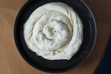 Woman making dough with meat at home