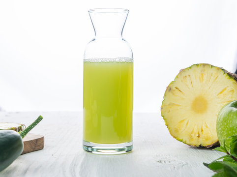 Pineapple, apple and cucumber juice in big glass