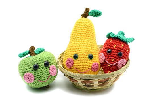 crochet fruits apple pear and strawberry with smiling face on white isolated  background