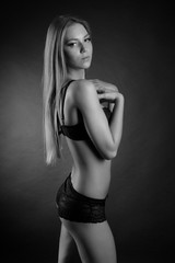 Naklejka premium young sexy girl in underwear on a black background