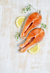 Salmon Trout Fish Cooking Raw Fillet Pepper Salt Olive Oil Rosemary Lemon Green Tomato Salad Wooden Table Lifestyle Healthy Concept