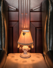 Ancient style lamp on table net to leather chairs