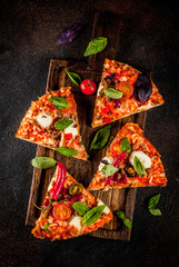 Pizza and red wine on dark background top view copy space