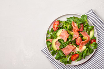 Fresh salad made of salmon, tomatoes and avocado