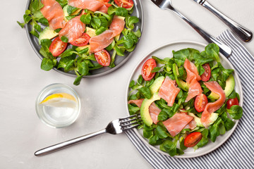 Fresh salad made of salmon, tomatoes and avocado