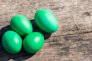 Painted Easter eggs on rustic wooden background