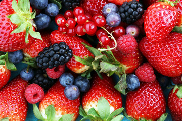 Berries overhead closeup colorful assorted mix of strawberry, blueberry, raspberry, blackberry and...