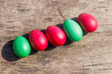 Painted Easter eggs on rustic wooden background