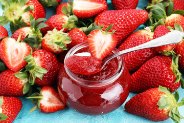 strawberry jam with fresh strawberries. marmalade on spoon and jar
