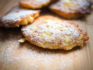 delicious pancakes with apples, pancakes with apples, sprinkled with white sugar.