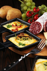 Delicious traditional Swiss melted raclette cheese on diced boiled or baked potato.