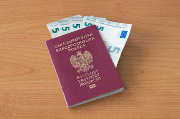 Polish biometric passport with five euro banknotes.