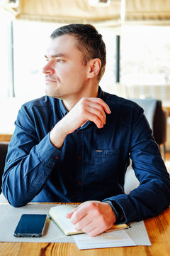 Young Caucasian Proffessional Man In Blue Shirt In Cafe