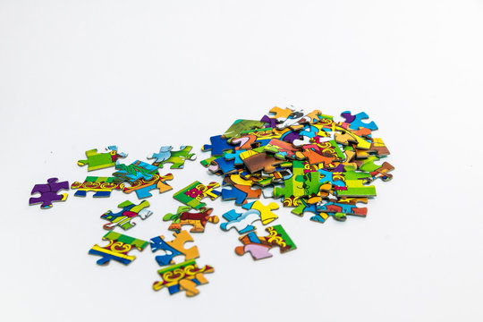 Multicolored puzzles scattered on a white background