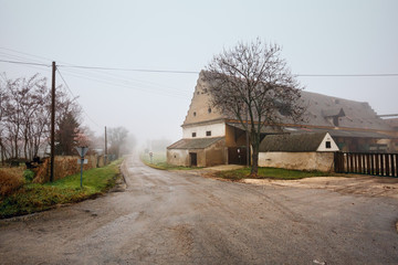 Farm house on a foggy winter day. Market town of Guntersdorf in the district of Hollabrunn, Lower Austria, Europe.