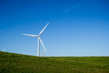 Windmills in open field