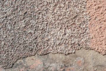surface of the old wall with exfoliating and falling off paint as a background, grey texture