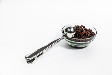 coffee beans in a transparent cup on a white background