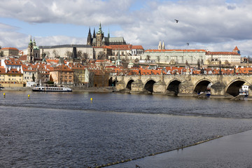 Obraz premium Early Spring Prague gothic Castle with the Lesser Town above River Vltava in the sunny Day, Czech Republic