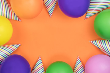 Birthday party composition on orange background. Top view with copy space.