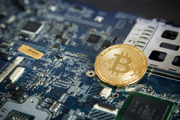 Gold Digital Cryptocurrency Coin on Computer Motherboard. Bitcoin Mining Concept. Crypto Currency Background.