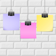 Office memo stickers on clip binders in gallery style hanging on the background of white brick wall. Info messages for posters, advertising, quotes. Empty reminders made in exhibition style.