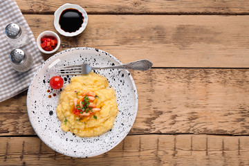 Plate with tasty shrimps and grits on table, top view