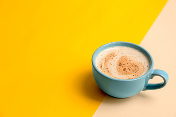 Cup of aromatic hot coffee on color background