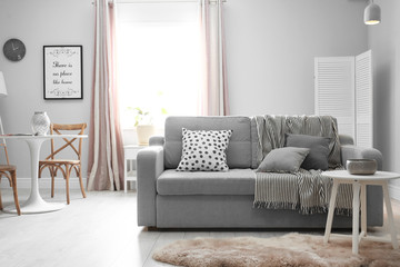 Fototapeta premium Stylish living room interior with comfortable couch