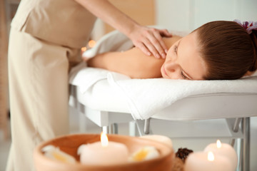 Fototapeta na wymiar Young woman having massage in spa salon